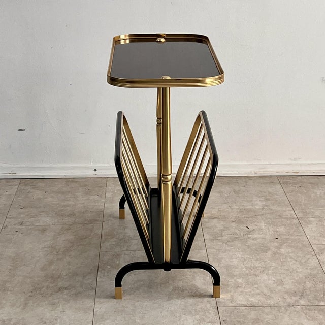 A refined Italian coffee table/side table with a built-in magazine rack dating back to the 1950s and 1960s. The piece...
