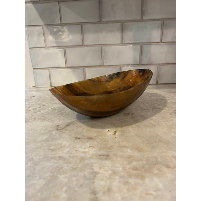 A striking oval bowl crafted from natural cattle horn, circa late 19th century. Made from a single piece, the bowl...