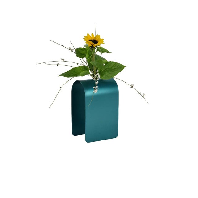 Characterized by a vivid and striking petrol blue shade, this bud vase is a testament to minimalist contemporary design....