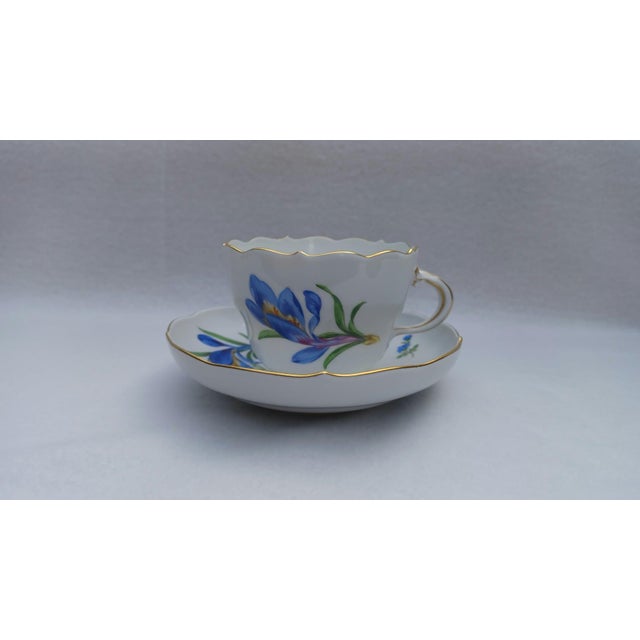 This elegant vintage porcelain cup and saucer duo set was manufactured by the world-renowned Meissen Porcelain Manufactory...
