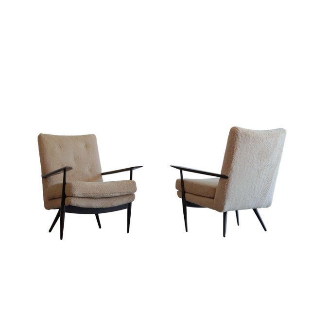 A vintage set of sculptural walnut lounge chairs, original from the 1970s. Reminiscent of George Nakashima's reverence for...