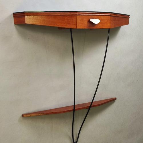 Refined Italian-designed wall console table from the 1960s. Mahogany frame with black glass top, drawer, and lower shelf...
