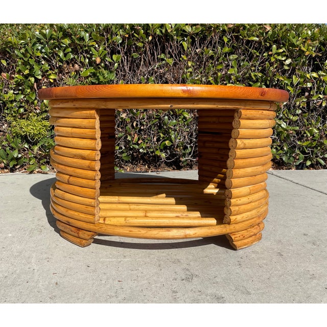 Unique and gorgeous vintage table! This 1940s gem features a stacked rattan structure with cutouts to access storage space...