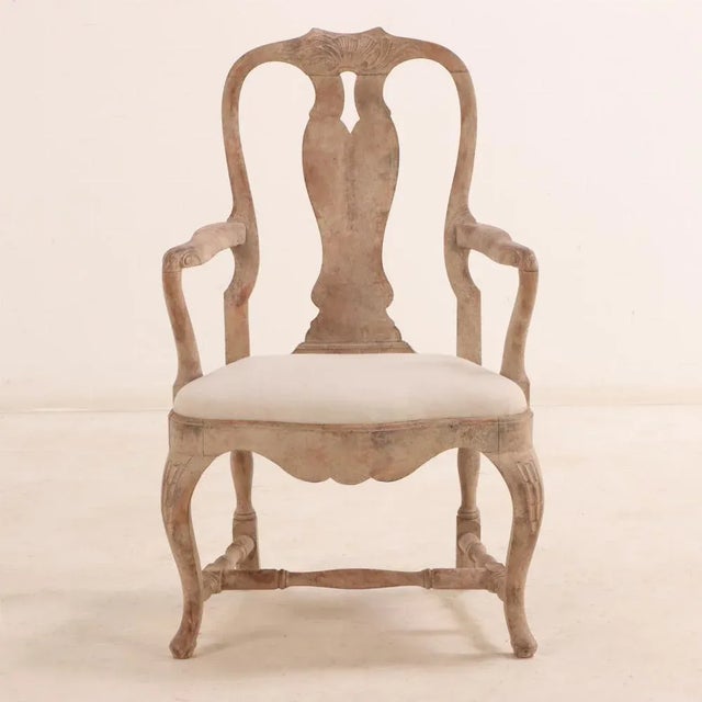A substantial pair of armchairs having graceful lines, they exhibit wonderfully carved crests and knees, comfortable and...