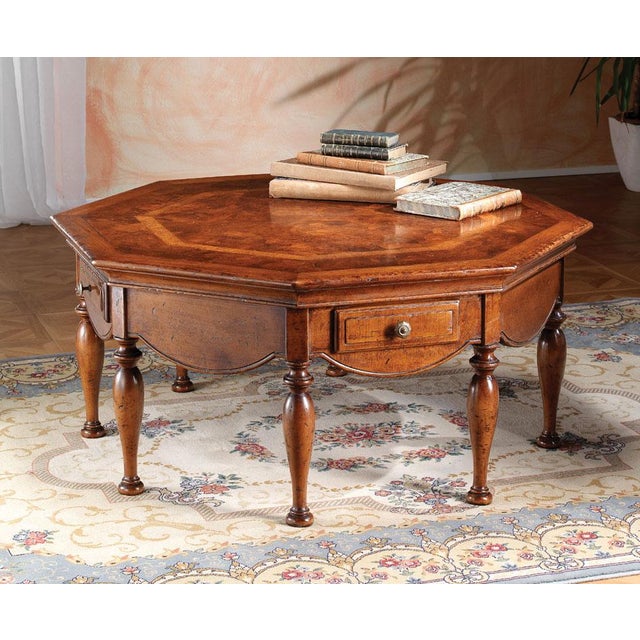 A masterful creation handcrafted in Italy from solid walnut. This unique table features an intricate top inlaid with a...