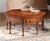A masterful creation handcrafted in Italy from solid walnut. This unique table features an intricate top inlaid with a...