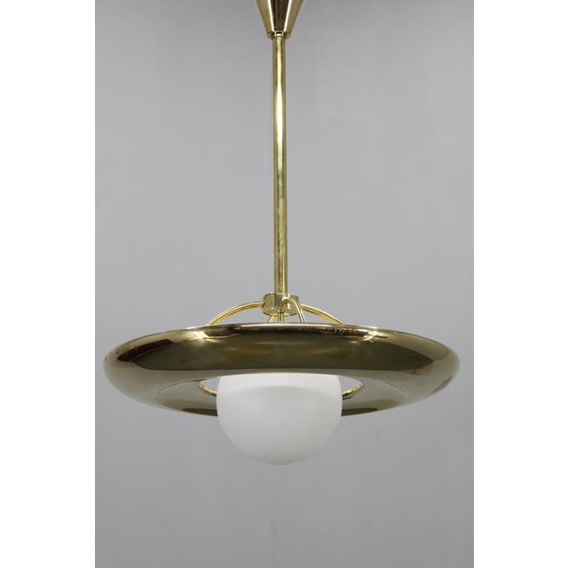 This elegant Art Deco chandelier was produced in Czechoslovakia in the 1930s. Crafted from polished brass and complemented...