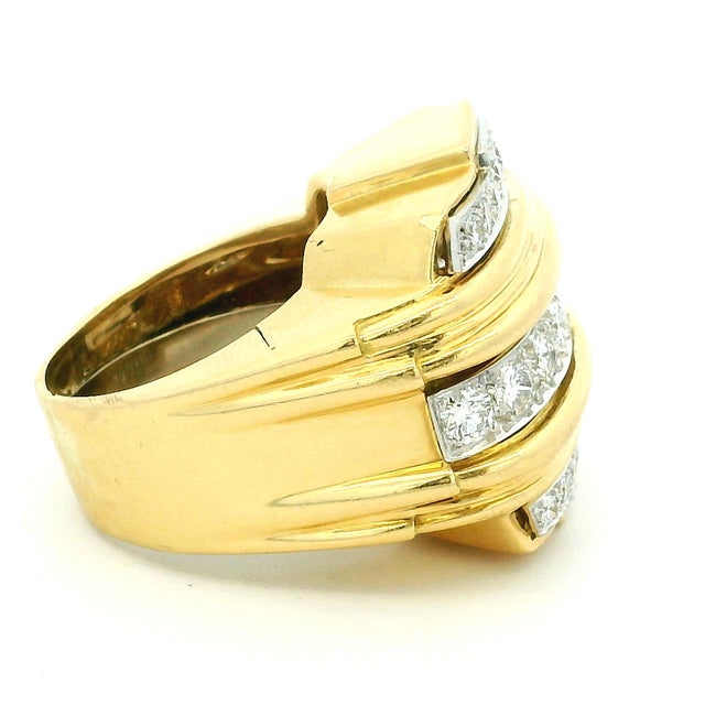 A bold and collectible David Webb diamond band ring crafted in 18K yellow gold and platinum, dating to the 1980s. This...