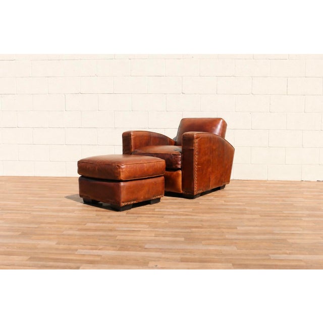 Wonderful vintage Art Deco Revival club chair with matching ottoman, circa 1980s. Upholstered in beautifully aged brown...