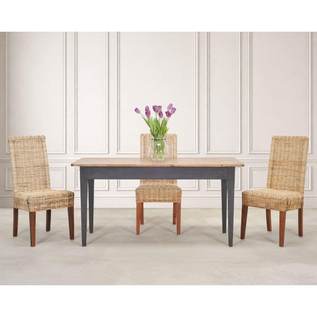 A charming weathered French Country Provincial farmhouse dining table, constructed in the late 19th century. The rustic...