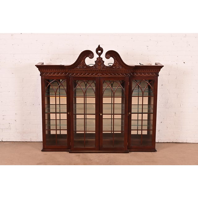 A gorgeous Georgian or Chippendale style lighted bookcase, dining cabinet, or display cabinet In the manner of Baker...