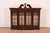 A gorgeous Georgian or Chippendale style lighted bookcase, dining cabinet, or display cabinet In the manner of Baker...