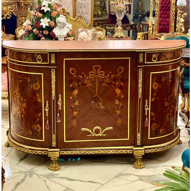 Bring timeless European elegance into your home with this grand French Louis XVI-inspired commode, featuring an impressive...