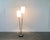 Elegant mid century floor lamp with two shades. A reserved and detailed design. The materiality and coloring in black and...