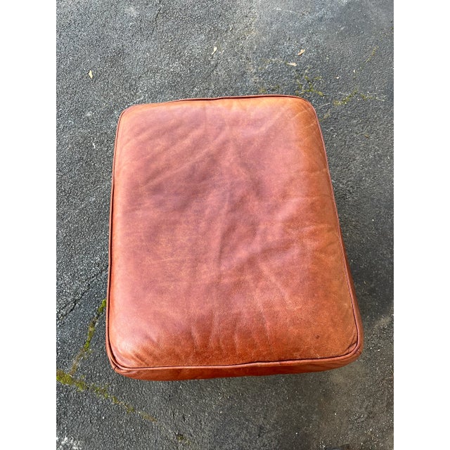 This George Smith Signature Run-Up Style Ottoman is in a beautiful chestnut brown leather on tapered wooden legs.