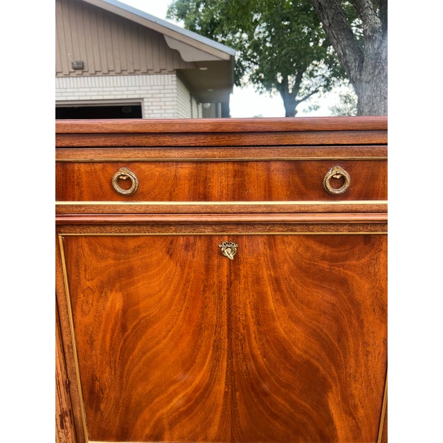 An elegant French Louis XVI secrétaire from the 19th century, crafted in richly figured mahogany with beautiful flame...