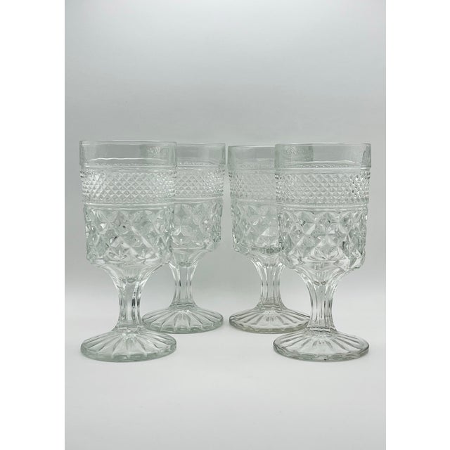 A set of four diamond pattern water goblets with starburst bases in very good condition.