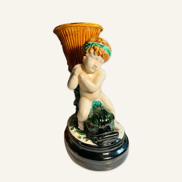 This matched pair of cornucopia vases or centerpieces features putti riding dolphin fish. The vase portion of the...