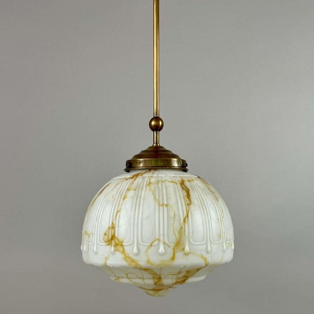This Art Deco pendant light was designed and manufactured in Germany in the 1930s. The fixture features a beautifully...