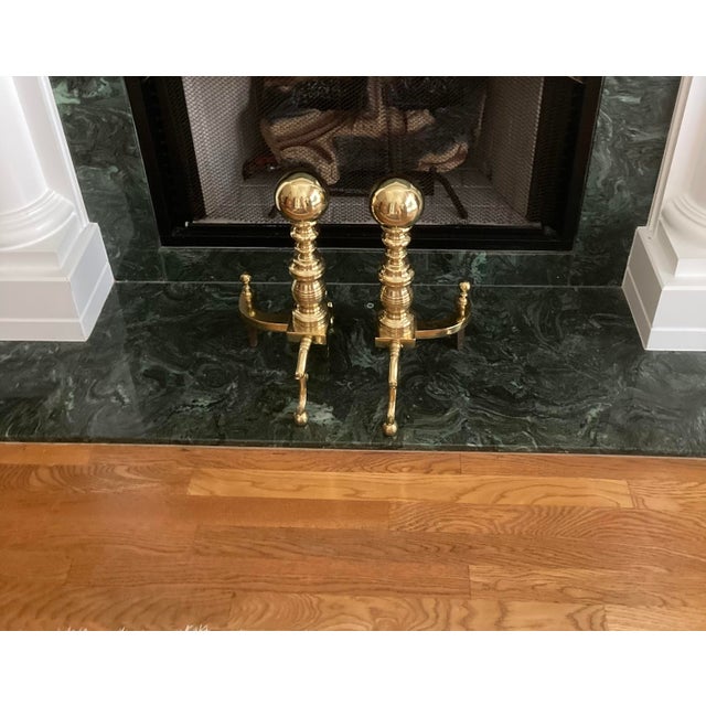 This is a pair of Classic Cast Brass Andirons in the Chippendale style featuring ornate shiny solid brass construction...