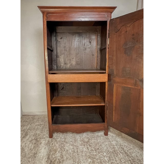 Handcrafted from solid French oak, this antique bonnetière embodies the quiet elegance and practical craftsmanship of...