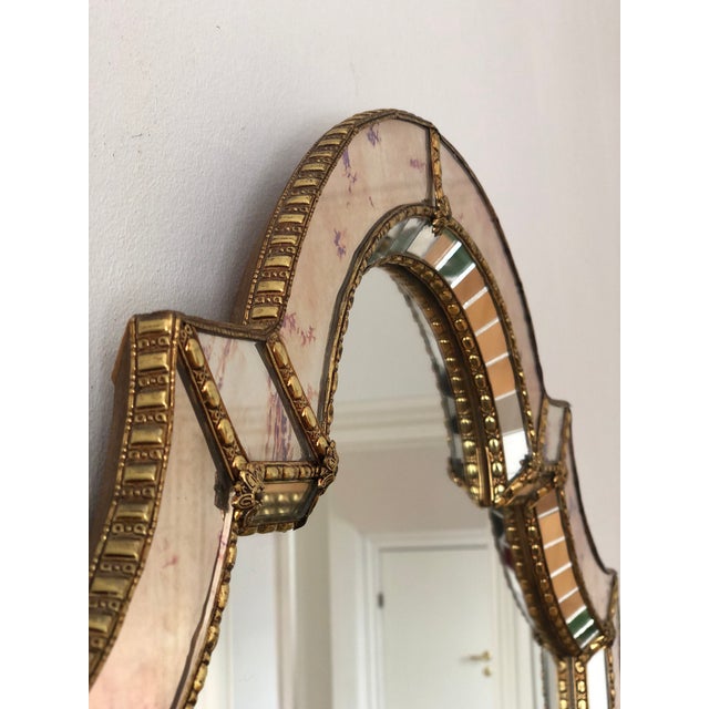 Large vintage Venetian beveled mirror in Spanish style, dating from the 1990s. The smoked glass frame is handcrafted and...
