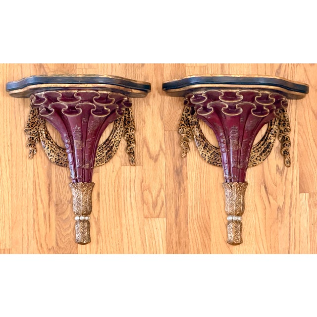 Pair of gorgeous decorative wall brackets. Hand painted chinoiserie scene, leopard swag and gold leafed accents. Antiqued...
