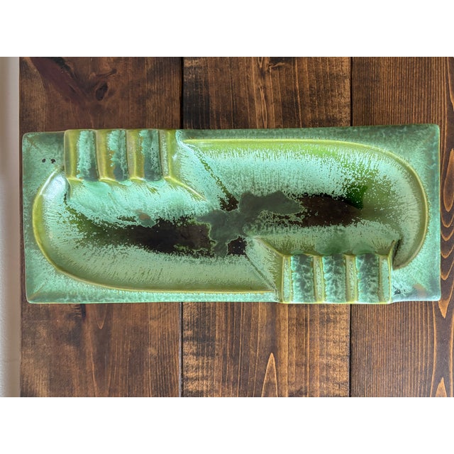 A large Midcentury Modern green ceramic cigar ashtray with a drip glaze finish. Add to your collection of vintage Atomic...