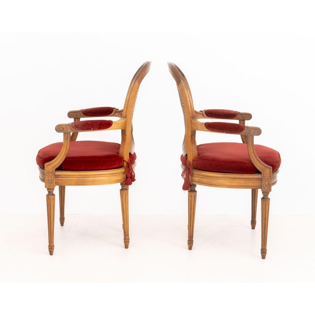 Pair of Louis XVI Style Red Velvet Upholstered Cane Paneled Walnut Fauteuils, each with removable cushion above fluted...