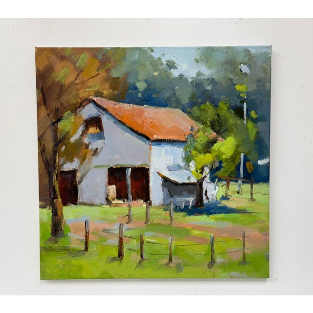 A charming and sunlit original oil painting on canvas capturing a peaceful farmstead in rich natural tones. The crisp...