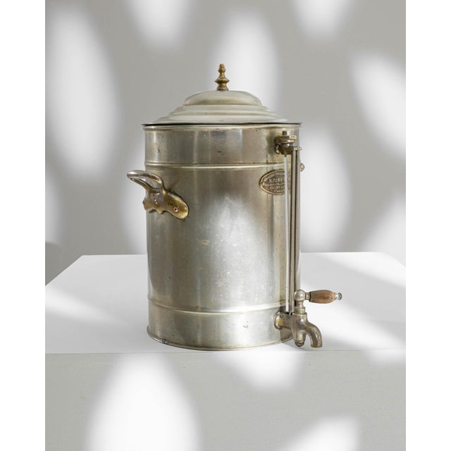 This Early 20th Century Belgian Metal Samovar is an elegant piece, exuding a sense of grandeur and function from an era...