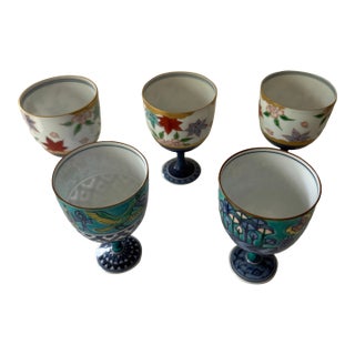Mid 20th Century Set of 5 Japanese Porcelain Footed Sake Goblets — Hand-Painted, Arita Style — Autumn, Garden & Egyptian Motifs For Sale