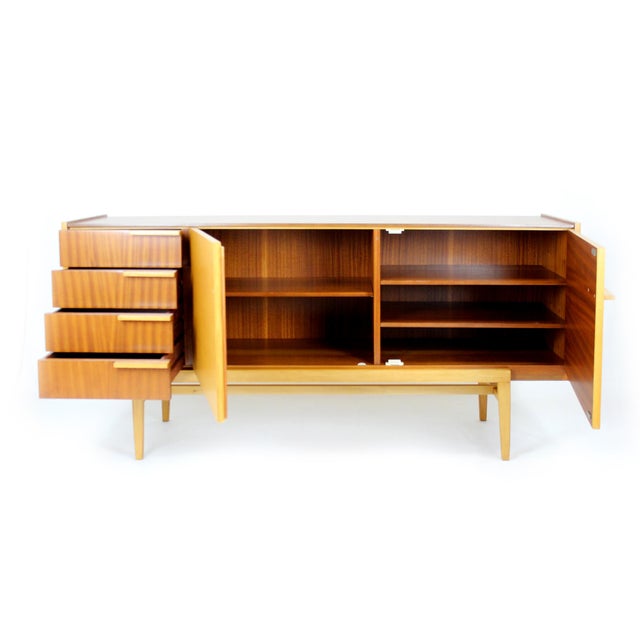 Mid-century sideboard from the 1960s by UP Zavody, Czech Republic, finished in a combination of mahogany and ash veneer....