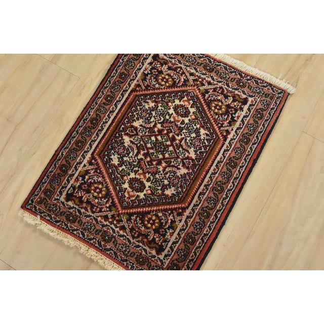 An authentic vintage traditional Bidjar rug hand-knotted with fine wool and natural dyes. This intricately woven rug...