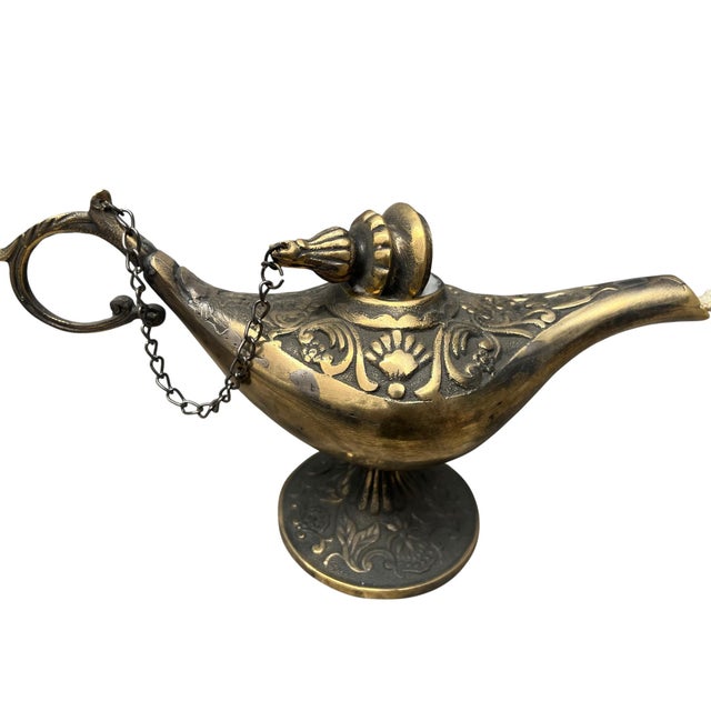 Bring the mThe Chained Guardian: Rustic Brass Genie Oil Lamp. Capture the essence of ancient folklore with this stunning...