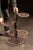 Early 20th-century cast iron three-tier plant stand featuring three independently adjustable circular platforms arranged...