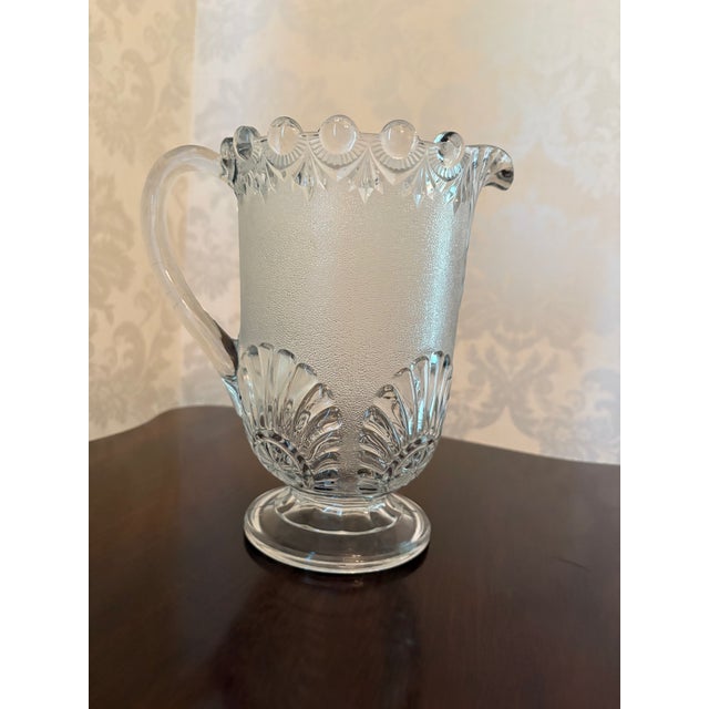 Beautiful footed pitcher in the delightful Shell and Jewel pattern by Westmoreland Glass. Ca. 1901. (Similar patterns were...