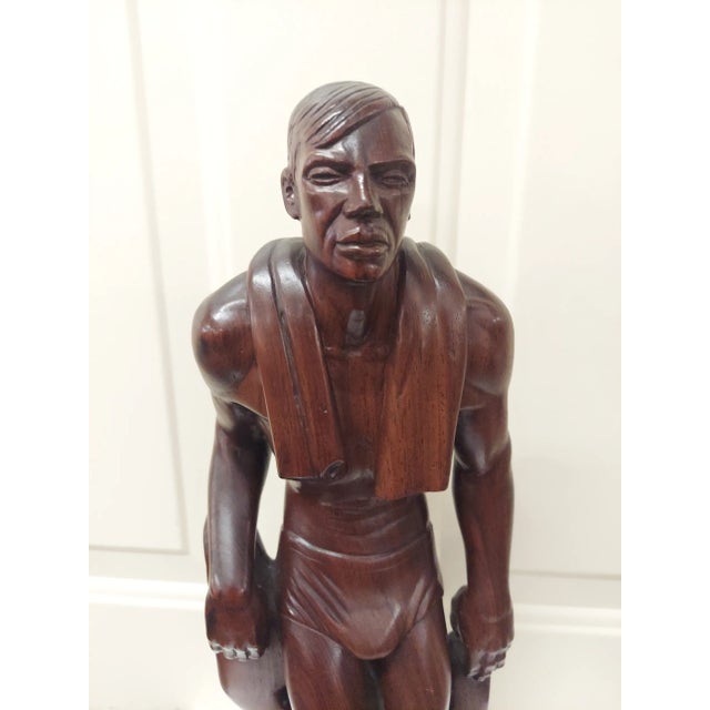 It is signed on the back. G. B. It appears to be made of rosewood. It depicts Buster Crabbe in a swimsuit. It measures 18"...