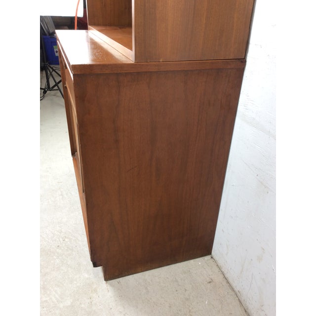 This mid century modern shelving unit by Basic-Witz features hardwood construction, walnut veneer with original finish,...