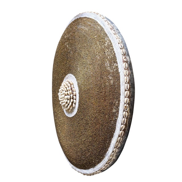 Supqerb African tribal round shield, meticulously hand made from native hardwood and adorned with intricate beadwork using...