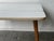 This is a Mid-Century drop-leaf dining / kitchen table with a clean, minimalist design. It features a rectangular top with...