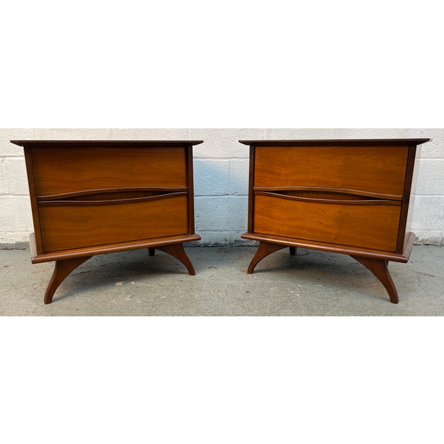 Pair of Mid-Century Walnut Nightstands With Sculpted Drawer Pulls. Dovetail joinery on drawers offer years of stable use....