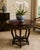 A striking Chinese Chippendale-style round center table featuring exceptional openwork carvings inspired by traditional...