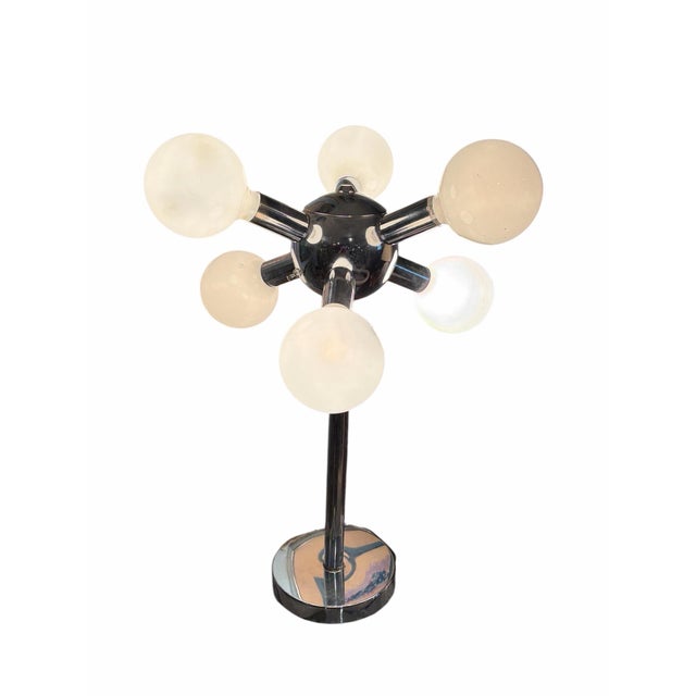 Mid-century modern chrome "Orbiter" or "Sputnik" style table lamp attributed to Robert Sonneman. Features a central...