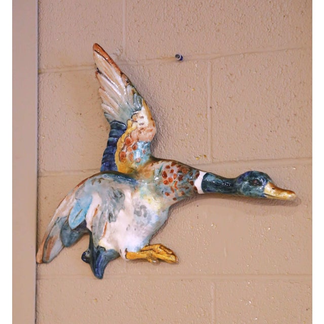 This striking antique French wall sculpture depicts a mallard duck in mid-flight, modeled in high relief with wings raised...