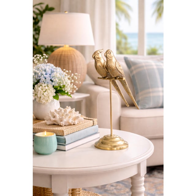 A stylish pair of vintage Mid-Century brass sculptural parrots or lovebirds perched on a stand with a lovely brass patina....