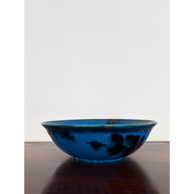 Large centerpiece bowl or decorative plate in stoneware, glazed in blue with stylised black designs, produced and designed...