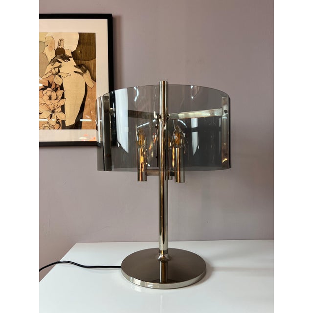 This table lamp from West Germany combines typical 1970s Space Age design with elegant functionality. The chrome frame...