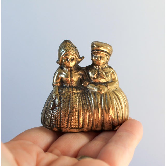 Petite vintage solid brass couple dinner bell. Made in England. Minor age wear.
