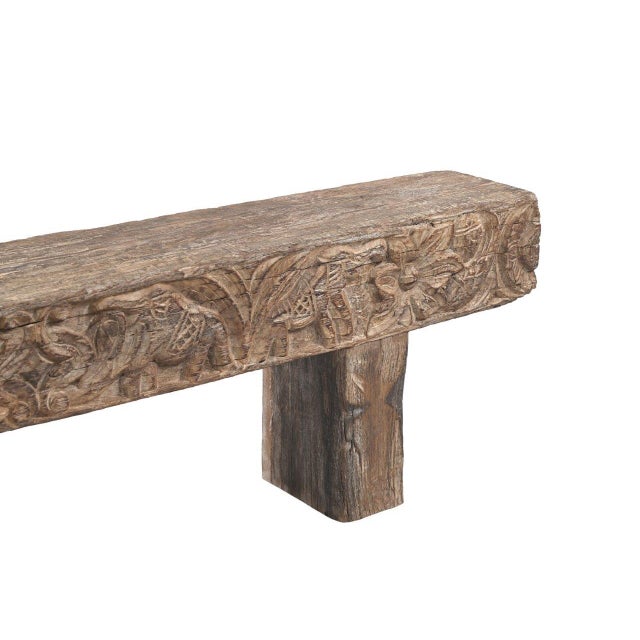 Handcrafted from solid teakwood, this Indian Carved Front Rustic Teakwood Bench features a boldly carved apron adorned...